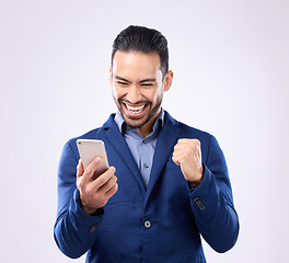 Image showing Business man, phone and celebrate success in studio for winning, deal or bonus. Happy male model isolated on gray background with smartphone for mobile app or internet competition or lottery winner