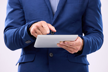 Image showing Man, tablet in hands and online in studio for communication with network connection on social media. Hand of business male typing for internet search, mobile app and chat with contact for marketing