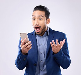 Image showing Business man, phone and wow for success in studio for winning, deal or bonus notification. Excited male model isolated on gray background with smartphone mobile app, internet competition or surprise