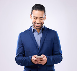 Image showing Asian man, business and phone in studio for communication and network connection. Happy male model isolated on a gray background with smartphone for mobile app, online chat and typing on internet