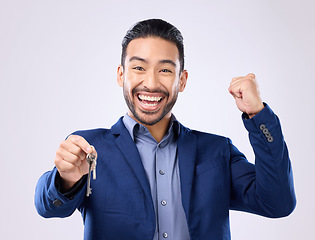 Image showing Realtor man, keys and studio portrait for celebration, fist hands or smile for new home, property or background. Happy asian businessman, real estate entrepreneur excited for buying of building