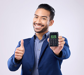 Image showing Business man, pos and studio portrait with thumbs up, fintech tick and payment security by grey background. Asian entrepreneur, sales expert and machine for purchase, buying and approve with success