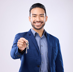 Image showing Realtor man, keys and studio portrait with smile, dream and excited face for new home, house or property on background. Happy asian businessman and real estate agent for professional buying