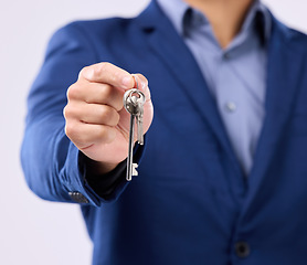 Image showing Realtor, keys and studio closeup of hands for man, new home or property by gray background. Businessman, real estate agent and entrepreneur for buying building, apartment and goals with key at job