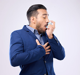 Image showing Business man breathe asthma pump in studio, medical health risk and cough treatment for chest pain. Sick male worker breathing medicine inhaler for lungs, oxygen and panic attack of allergy emergency