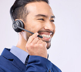 Image showing Call center, headset and happy man isolated on a white background for telemarketing, telecom or global support. Asian international agent, consultant or business person for virtual salesman in studio