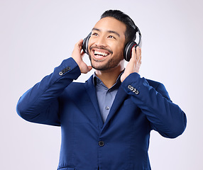 Image showing Executive man, music headphones and thinking on studio background of happiness, motivation and inspiration. Happy corporate worker listening to audio, sound and business podcast on radio with smile