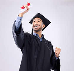 Image showing Student man, celebration and diploma in studio with happiness, success and achievement of life goals. Asian guy, happy and certificate for graduation from college, university or academy with smile