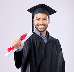 Image showing Graduate man, studio portrait and diploma in hand for learning achievement, education or goal by background. Happy student, certificate or smile for success, award and excited for college graduation