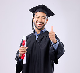 Image showing Graduation man, diploma and thumbs up in studio portrait for achievement, education or goals by background. Happy student, certificate or smile for success, award or excited graduate with celebration