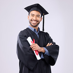 Image showing Graduation man, diploma and arms crossed in studio portrait with smile, success and pride for achievement. College graduate, asian student and certificate with goals, motivation and excited for award