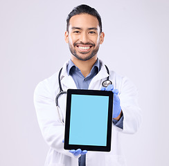 Image showing Tablet, green screen and doctor portrait isolated on a white background technology for telehealth service mockup. Medical professional or healthcare asian man with digital app mock up space in studio