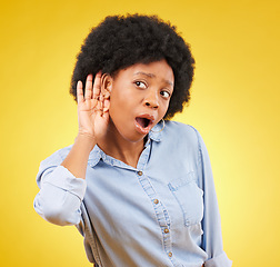 Image showing Shock, secret and black woman listening in a studio with a wow, wtf or omg face expression. Gossip, surprise and curious African female model with an afro with a listen gesture by a yellow background