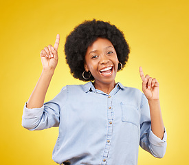 Image showing Promotion, happy portrait or black woman point at mock up space, advertising mockup or marketing promo. Commercial girl, studio gesture and excited person with product placement on yellow background