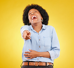 Image showing Pointing, laughing and fun with a black woman in studio on a yellow background enjoying a funny joke. Comic, comedy and laughter with an attractive young female feeling silly, goofy or playful