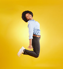 Image showing Happy, excited and portrait of black woman jump on yellow background with energy, happiness and smile in studio. Winner mockup, celebration and isolated girl jumping for freedom, winning and success