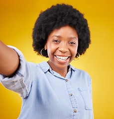 Image showing Portrait, selfie and black woman in studio happy, smile and confident against yellow background. Face, social media and girl influencer posing for photo, profile picture or blog update or vlog post