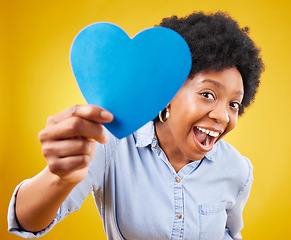 Image showing Paper, heart and excited with black woman in studio for romance, positive and emotion. Happiness, love shape and giving with female isolated on yellow background for date, feelings and affectionate