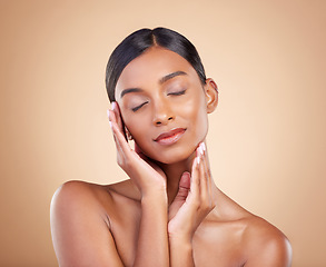 Image showing Skincare, self love and hands on face of woman in studio for beauty, wellness and relax on brown background. Skin, satisfaction and girl model enjoy body care, cosmetics and treatment while isolated