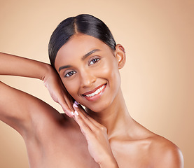 Image showing Portrait, skincare and happy with a model woman in studio on a beige background for natural beauty. Face, smile and makeup with an attractive young female posing for cosmetics or luxury wellness