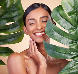 Image showing Woman, face and smile with leaf for natural skincare cosmetics, self love and care against studio background. Happy female beauty holding leafy green organic plant in sustainable eco facial treatment