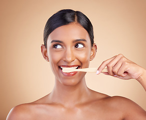 Image showing Woman, thinking and brushing teeth for dental care, dentist or healthcare and skincare against studio background. Happy female hands with toothbrush for healthy clean oral, mouth or gum hygiene