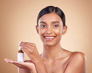 Image showing Portrait, beauty and antiaging serum with a model woman in studio on a beige background to promote skincare. Face, product and collagen with an attractive young female posing for luxury cosmetics