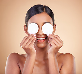 Image showing Beauty, cotton pads and woman with skincare, dermatology and girl against a brown studio background. Female, lady and makeup with treatment, grooming and happiness with smooth, soft and clear skin