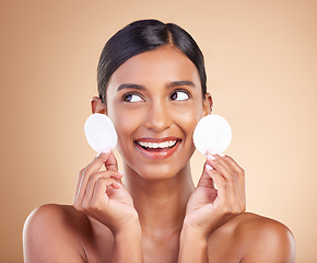 Image showing Smile, happy or woman with cotton pad in studio isolated on beige background for facial skincare. Face headshot, natural beauty or beautiful young Indian girl with luxury self care or glowing results