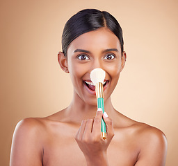 Image showing Portrait of woman, funny or makeup brush for beauty, cosmetic beauty or self care in studio background. Happy, model face or crazy eyes of Indian girl with cosmetics brush, skincare or application