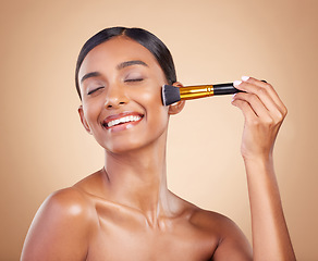 Image showing Happy woman, brush or makeup artist with beauty, cosmetic products or self care on studio background. Eyes closed, model face or young Indian girl with cosmetics, glowing skincare or facial smile