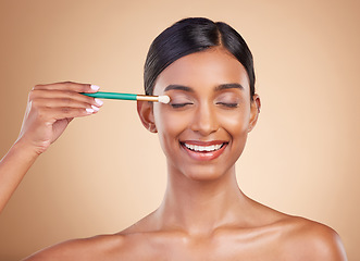 Image showing Makeup brush, eyes closed or happy woman with beauty, facial products or luxury self care on studio background. Model face or young Indian girl with eyeshadow cosmetics, glowing skincare or smile