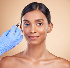 Image showing Portrait, smile or Indian woman with injection for plastic surgery, beauty or medical cosmetics in studio. Skincare, dermatology or hand with needle for face lift or facial treatment on happy girl