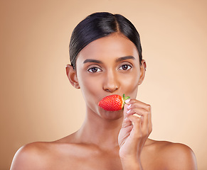 Image showing Eating strawberry, portrait or healthy Indian woman with skincare beauty or wellness in headshot. Food nutrition, face or young girl model with vitamin c or red fruits isolated on studio background