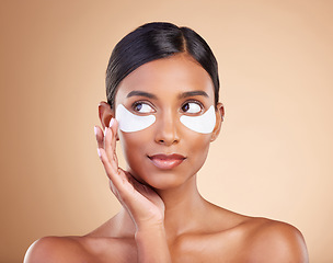 Image showing Face, skincare or Indian woman with eye patch for beauty isolated on studio background. Cosmetics or girl model with facial collagen pads or dermatology product for anti aging, hydration or wellness