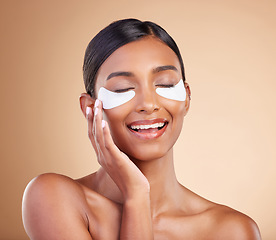 Image showing Face, skincare or happy woman with eye patch for beauty or wellness isolated on studio background. Cosmetics or girl model with facial collagen pads or dermatology product for anti aging or hydration