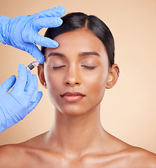 Image showing Studio, face lift or Indian woman with injection for beauty, plastic surgery or medical cosmetics. Skincare, dermatology or hands with needle in filler facial treatment on young girl with eyes closed