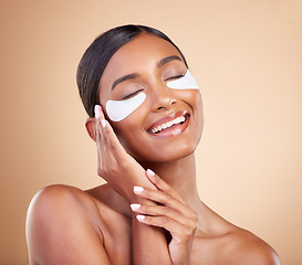 Image showing Face, smile or happy woman with eye patch for beauty or skincare isolated on studio background. Cosmetics or girl model with facial collagen pads or dermatology product for anti aging or dark circles