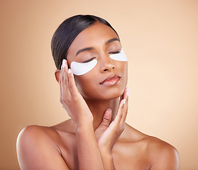 Image showing Face, beauty or girl with eye patch for skincare or wellness isolated on studio background. Cosmetics or Indian woman with facial collagen pads or dermatology product for anti aging or dark circles