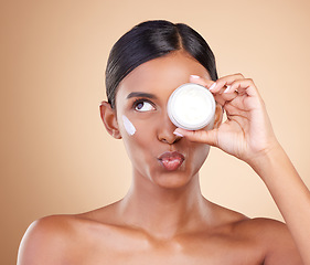 Image showing Face, skincare or Indian woman with cream for beauty or wellness isolated on studio background. Cosmetics or girl model with facial self care or dermatology product for anti aging or dark circles