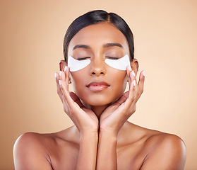 Image showing Face, beauty or Indian woman with eye patch for skincare or wellness isolated on studio background. Cosmetics or girl model with facial collagen pads or dermatology product for anti aging or glow