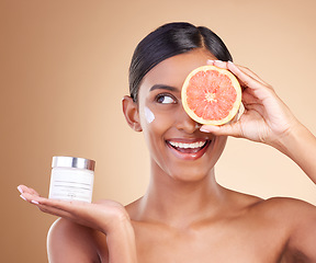 Image showing Grapefruit, skincare or happy woman with cream product for beauty or young face isolated on studio background. Cosmetics, smile or Indian girl with facial moisturizer or dermatology lotion for glow