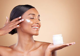 Image showing Smile, skincare or happy woman with cream product for beauty or young face isolated on studio background. Body cosmetics, youth or Indian girl with facial moisturizer or dermatology lotion for glow