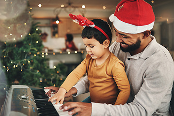 Image showing Happy father, child and piano for christmas celebration, songs and xmas hymn at home. Parent, boy kid and teaching keyboard instrument, festive music and celebrate fun holiday spirit with audio sound