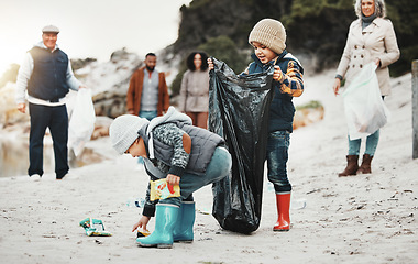 Image showing Beach cleaning, plastic and children, family or volunteer group in education, learning and community service. Happy people and kids help with waste, garbage or trash in climate change or pollution