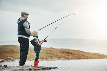 Image showing Lake, travel and grandfather fishing with a kid while on a adventure, holiday or weekend trip. Hobby, outdoor and elderly man teaching a child to catch fish in nature while on vacation in countryside