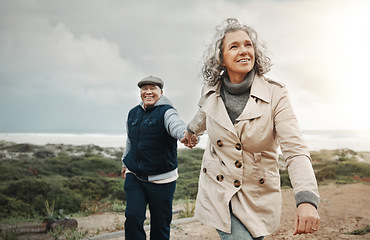 Image showing Beach, love and senior couple holding hands on romantic evening walk in nature on happy date. Smile, romance and retirement, old woman and man walking on ocean path at sunset on holiday in Australia.