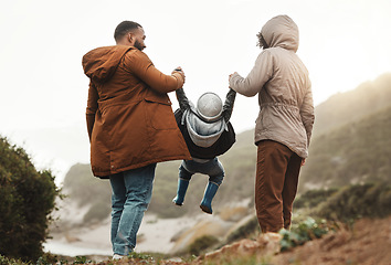 Image showing Nature fitness, holding hands and hiking family of mother, father and child walking, play and bond on mountain adventure. Love, freedom peace or back view of winter people trekking on outdoor journey