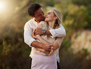 Image showing Couple, love and hug outdoor at sunset for love, care and romance on date. Young man and woman together on valentines day with flare, peace and freedom in nature forest with trust, support and smile