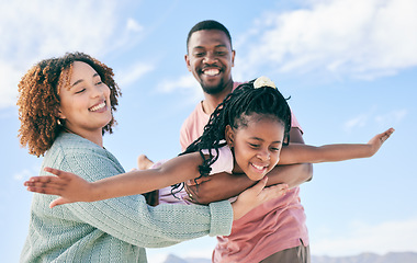 Image showing Happy family, fly or girl with parents at beach on summer holiday vacation or weekend together. African dad, funny mother or excited child love bonding, laughing or relaxing while playing in nature